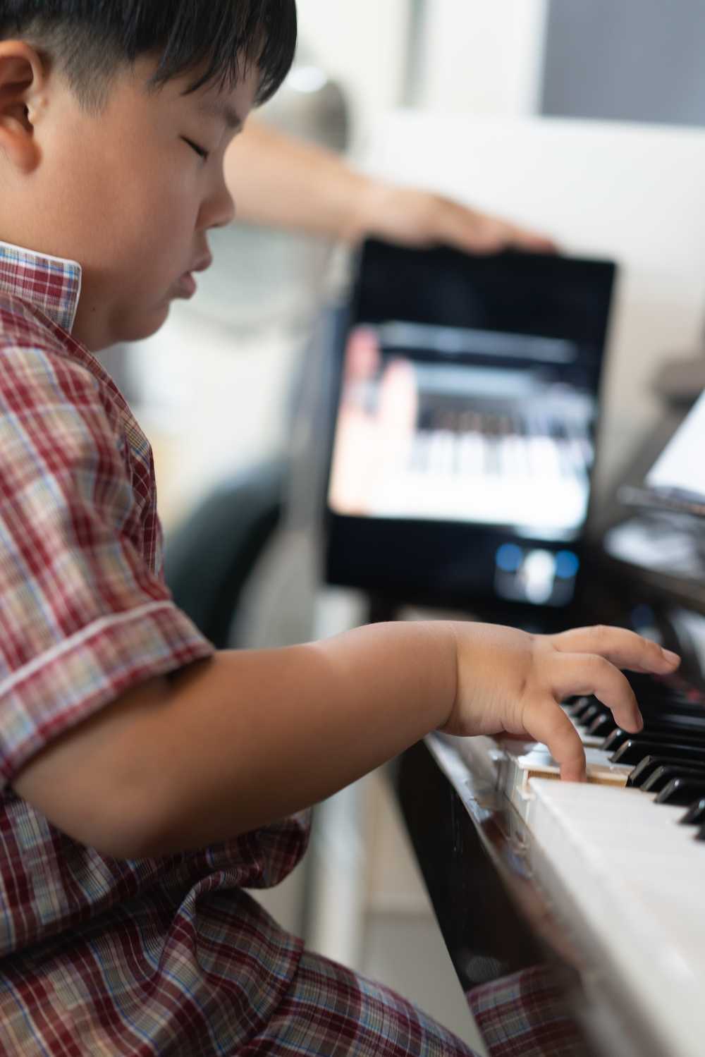 Child performs on the piano online