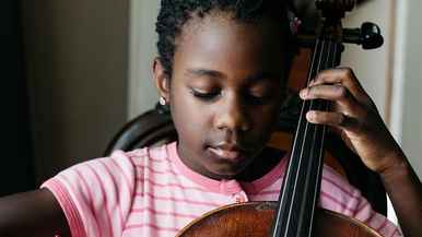 Young girl playing the cello