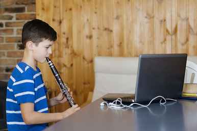 An online clarinet lesson with a young boy