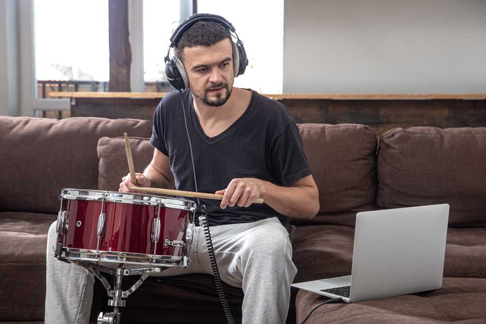 A student taking an online drum lesson